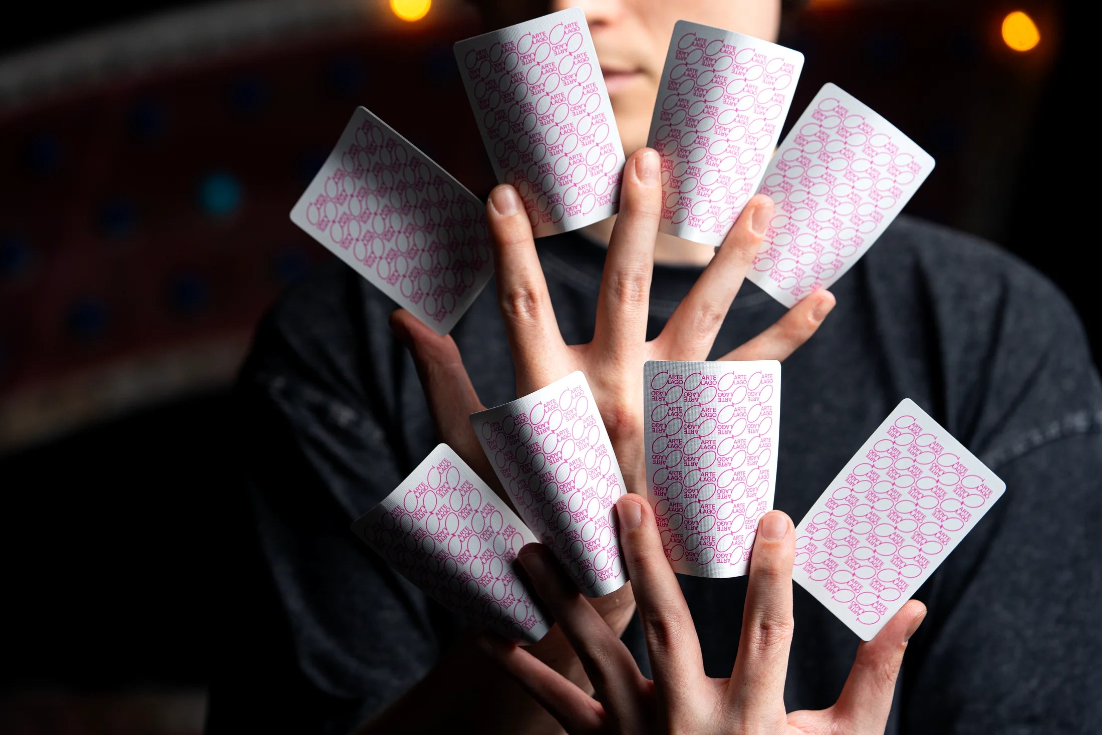 Players cards arranged across a cardist's hands
