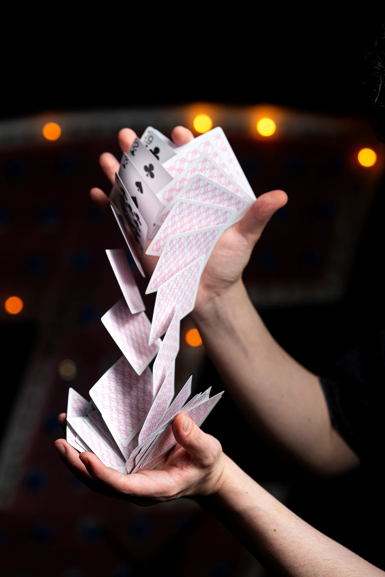 Players pink playing cards in motion