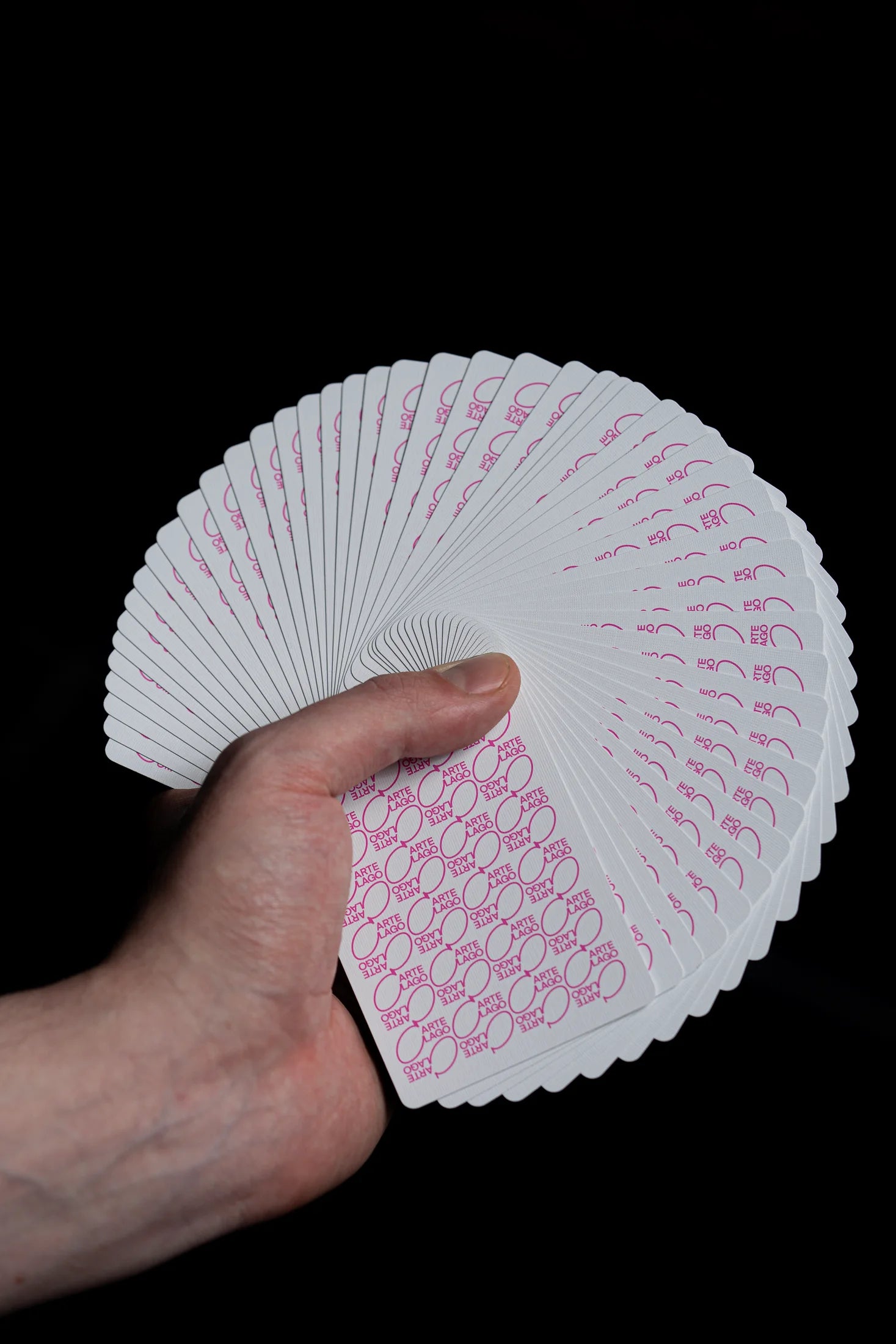 Players pink playing cards opened in a full fan