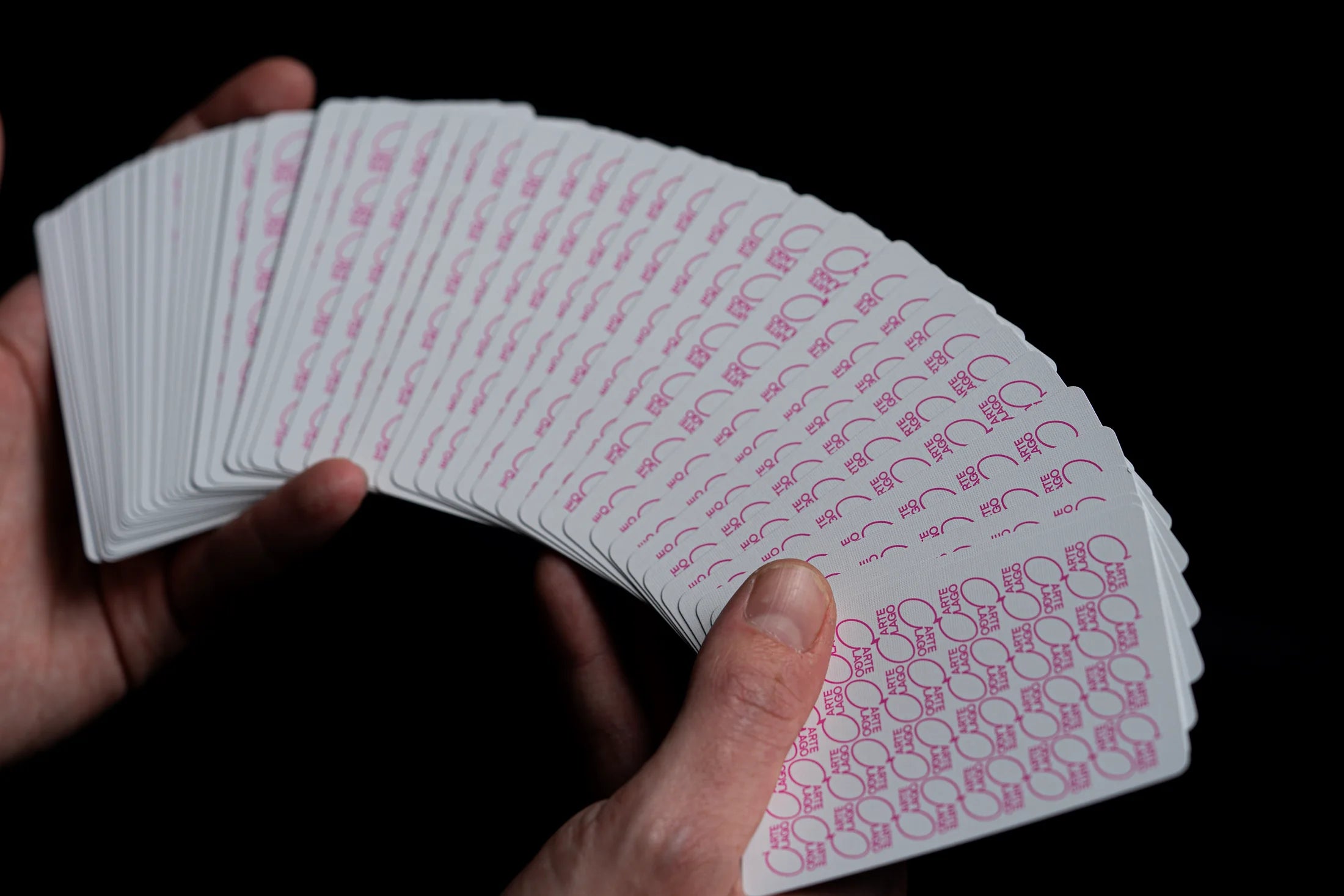 Players pink cards spread across a hand