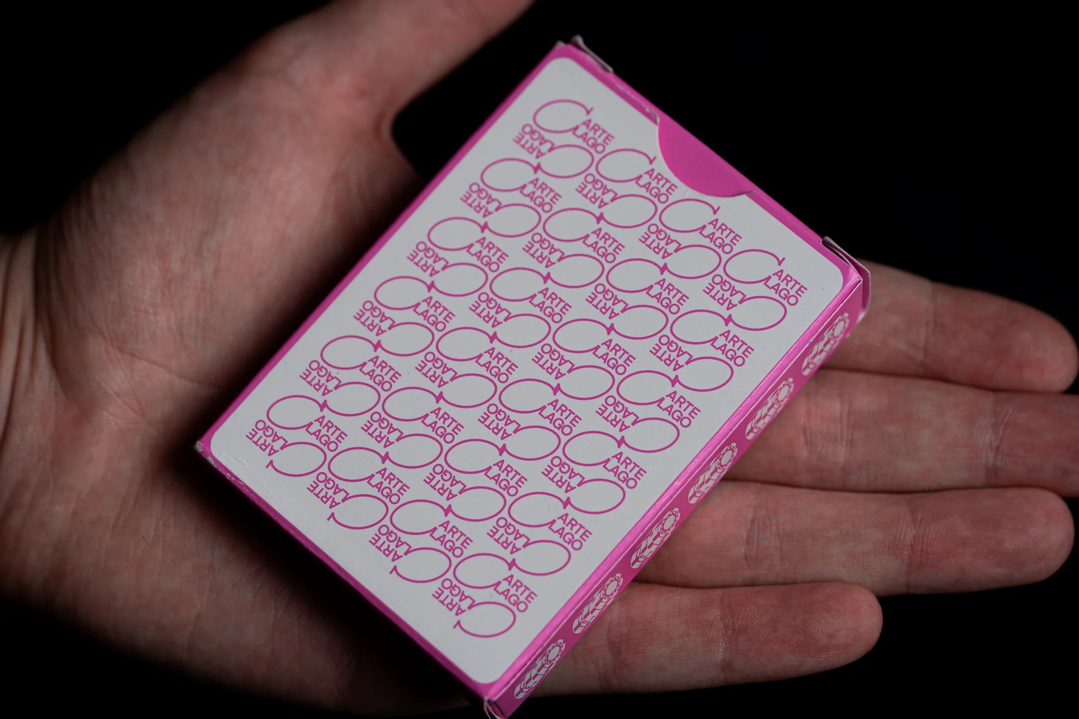 Players pink playing-card tuck box held in hand